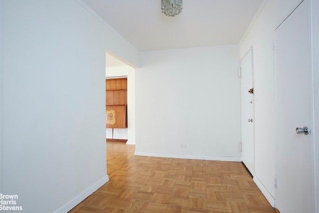 hall with crown molding and light parquet floors