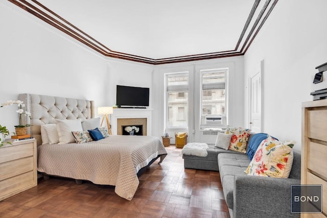 bedroom featuring ornamental molding, cooling unit, and dark parquet floors