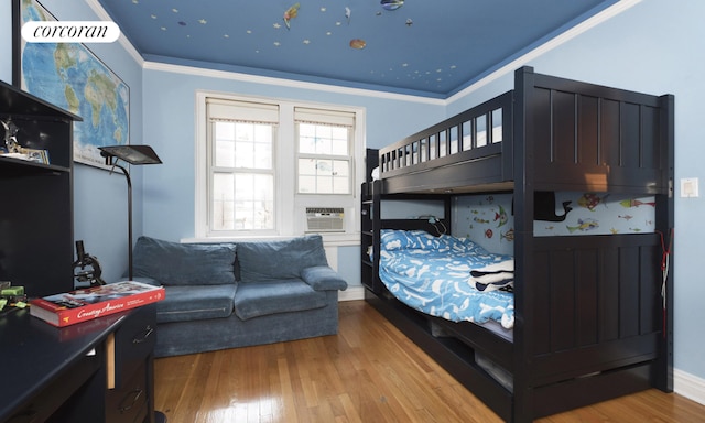 bedroom featuring ornamental molding, cooling unit, and hardwood / wood-style floors