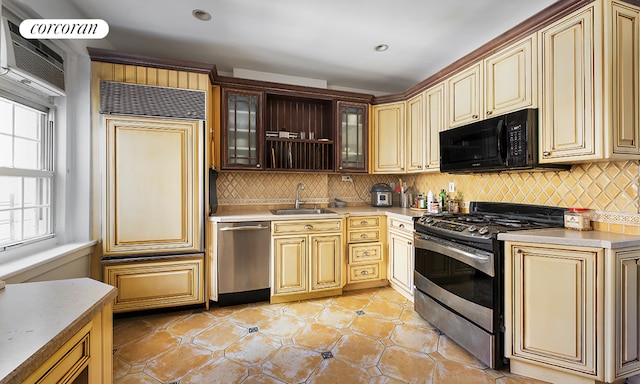 kitchen featuring backsplash, appliances with stainless steel finishes, and sink