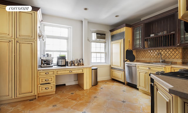 kitchen with light tile patterned flooring, sink, stainless steel dishwasher, and tasteful backsplash