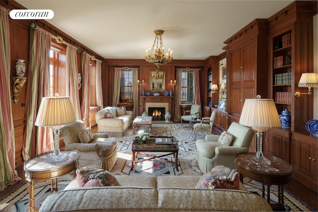 895 Park Ave Phc, Phc, New York City, NY 10075 - living room with a lit fireplace and a chandelier