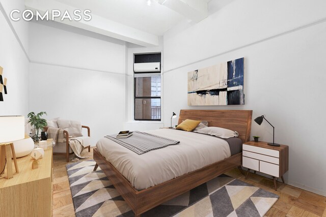 bedroom featuring parquet floors and beam ceiling