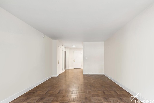 empty room with dark parquet floors