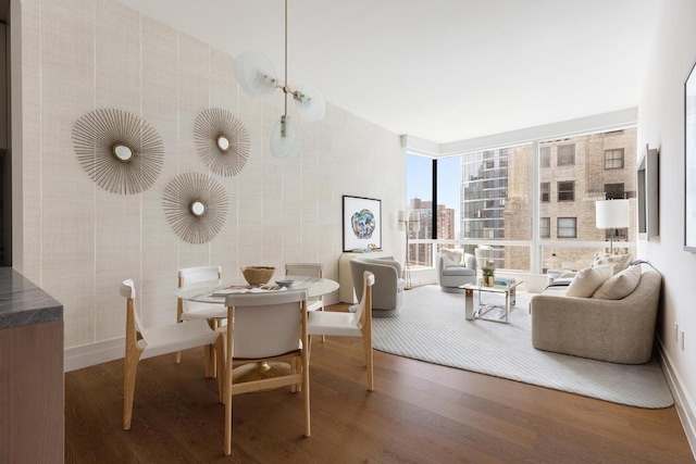 dining space featuring hardwood / wood-style flooring and expansive windows