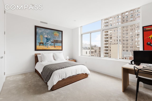 carpeted bedroom with visible vents and baseboards