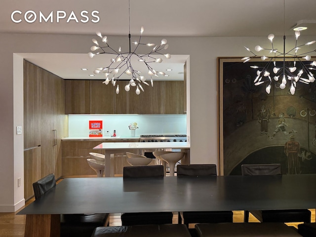 dining space featuring a chandelier and wood finished floors