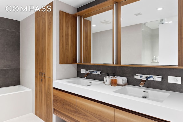 full bathroom with tasteful backsplash, visible vents, a sink, and double vanity