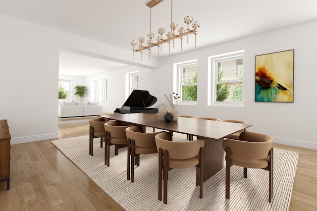 dining area with light wood finished floors and baseboards