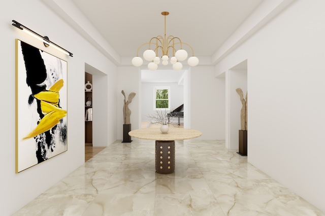 corridor with marble finish floor and an inviting chandelier