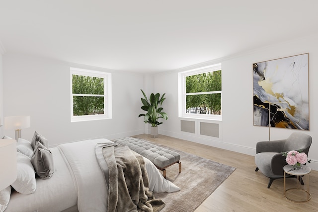 bedroom featuring visible vents, multiple windows, baseboards, and wood finished floors