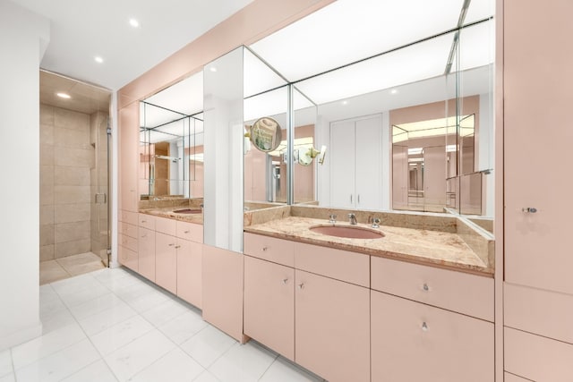 bathroom featuring vanity, tile patterned floors, and a shower with door