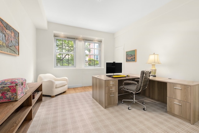 office space with light wood-type flooring