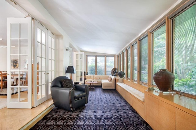 sunroom / solarium featuring lofted ceiling and french doors