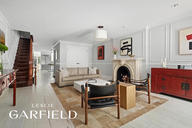 living room featuring ornamental molding and light wood-type flooring