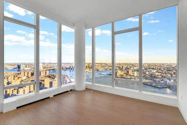 unfurnished sunroom featuring a water view