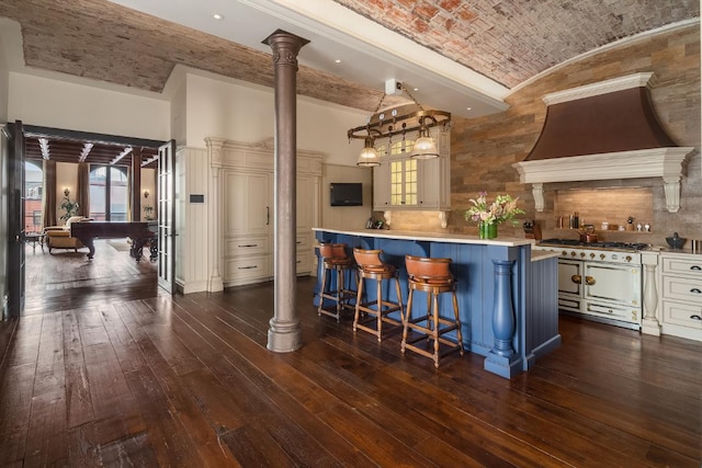 kitchen with brick ceiling, dark hardwood / wood-style floors, and custom exhaust hood