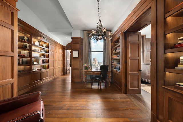 office featuring dark wood-type flooring and a chandelier