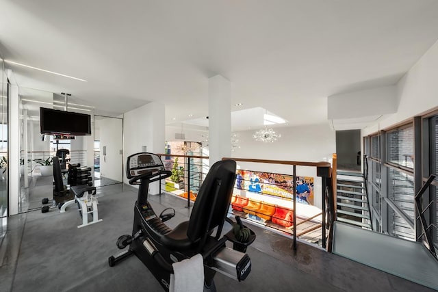 gym with an inviting chandelier