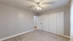 unfurnished bedroom with a closet and ceiling fan