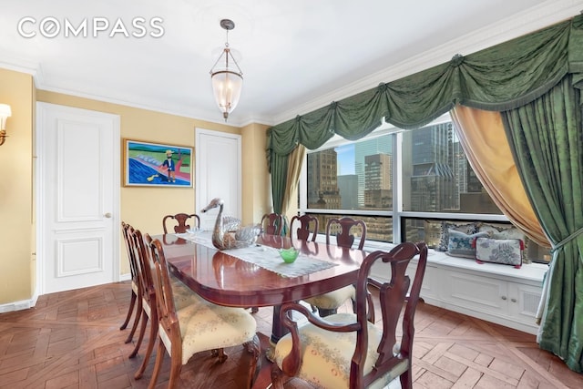 dining space with baseboards and crown molding