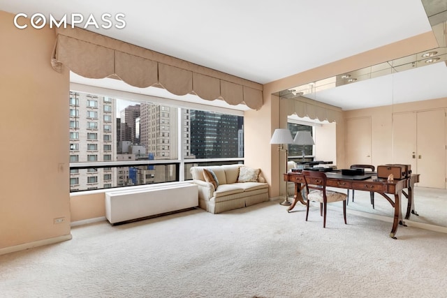 office area featuring carpet floors, a view of city, and baseboards