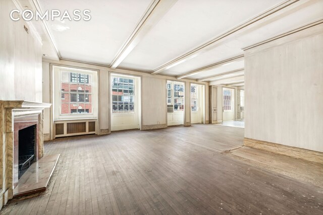 empty room with dark parquet flooring, a chandelier, and beam ceiling