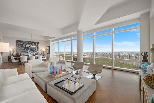 living room featuring expansive windows and a notable chandelier