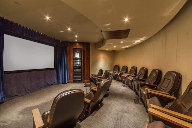 home theater with light colored carpet and wood walls