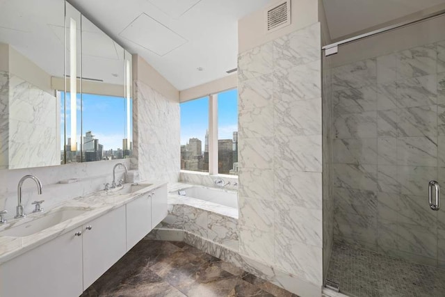 bathroom with vanity and separate shower and tub