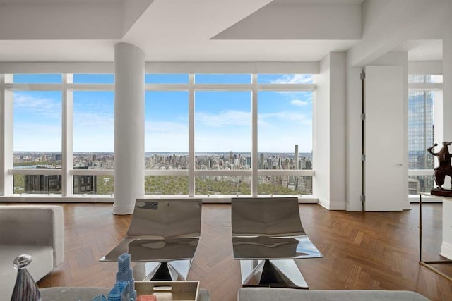 dining space with a wealth of natural light, dark parquet floors, and expansive windows