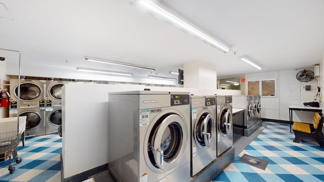 community laundry room with independent washer and dryer and stacked washer and clothes dryer