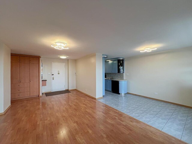 unfurnished bedroom with a closet and light hardwood / wood-style flooring