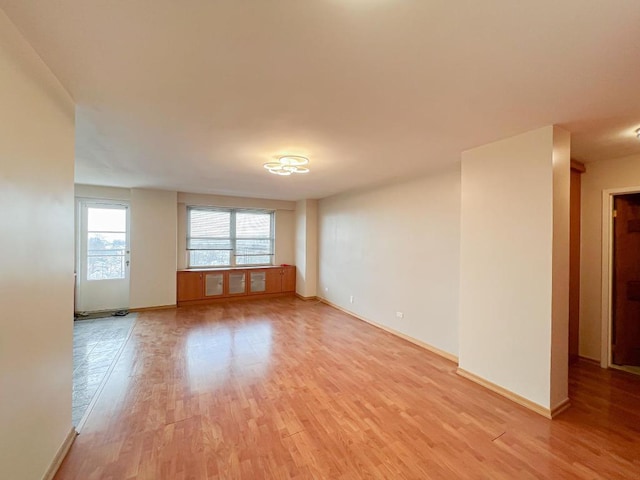 spare room featuring light wood-type flooring