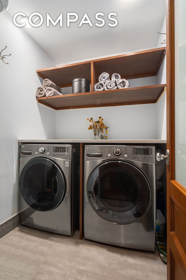 laundry area featuring light tile patterned floors, independent washer and dryer, and laundry area