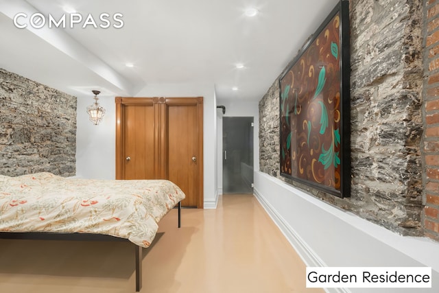 bedroom with recessed lighting and concrete floors