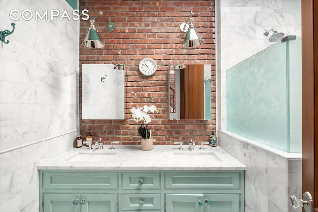 full bathroom featuring a sink, tile walls, and double vanity