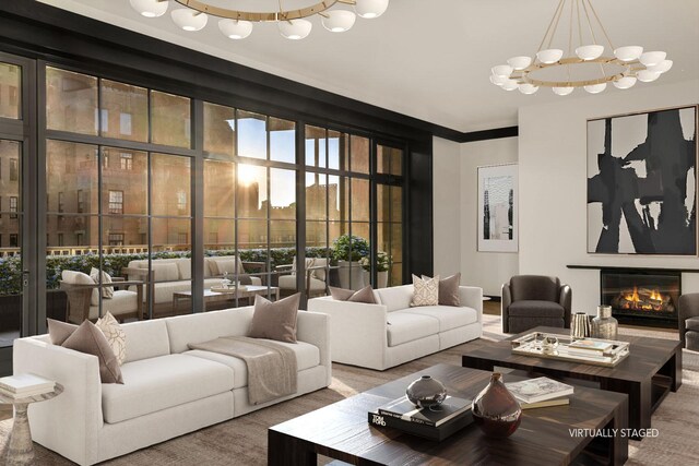 living room with a high end fireplace, ornamental molding, and light parquet flooring