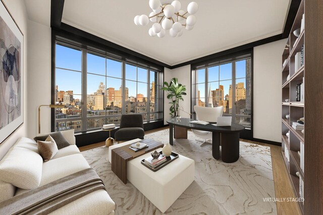 sitting room with built in shelves, ornamental molding, and light parquet flooring