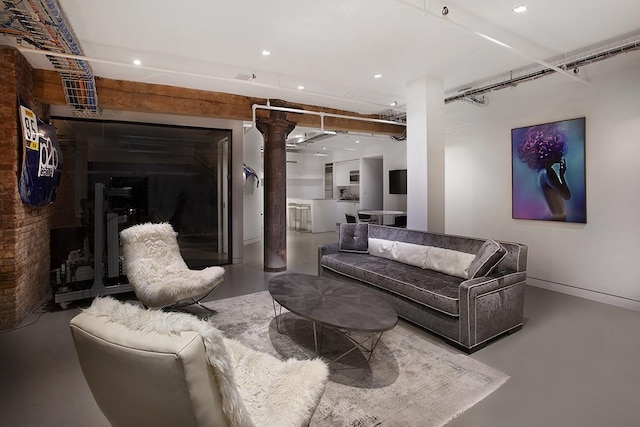 169 Hudson St Unit 1-N, New York City, NY 10013 - living room featuring concrete flooring, ornate columns, and recessed lighting