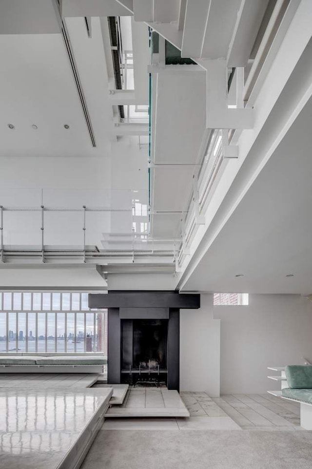 interior space with a fireplace with raised hearth