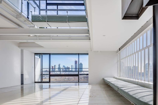 corridor with a wall of windows and a city view