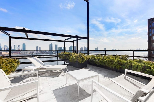 view of patio with a water view and a city view