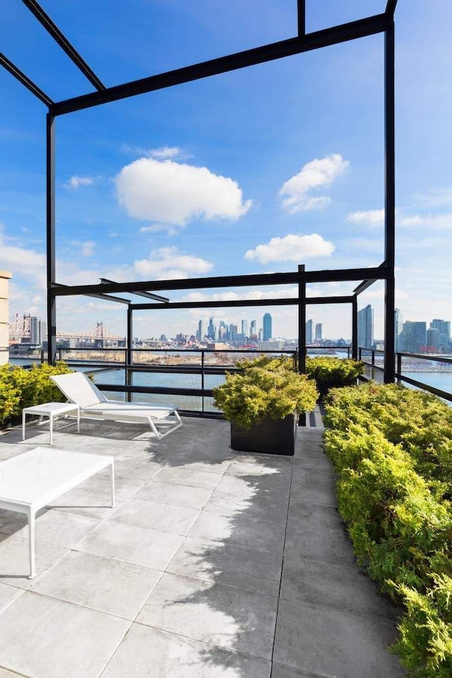 view of patio with a water view and a city view