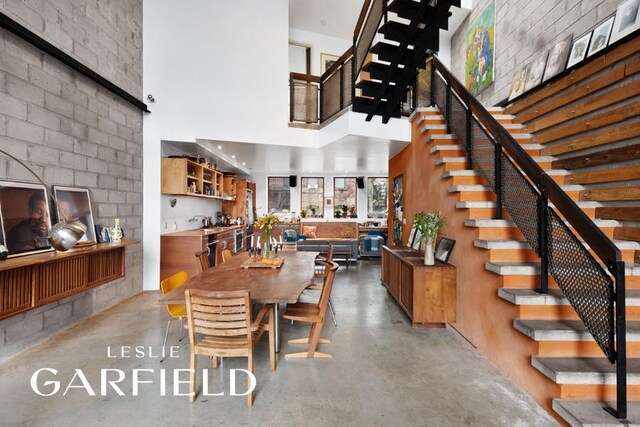 living room with a wall of windows and a high ceiling