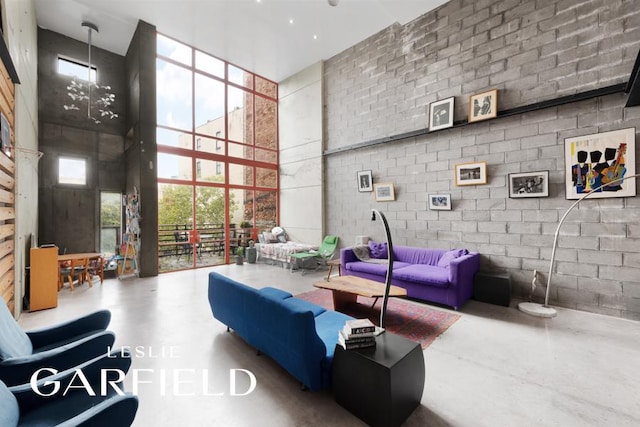 56 E 1st St, New York City, NY 10003 - living room with a wall of windows, a towering ceiling, and finished concrete flooring
