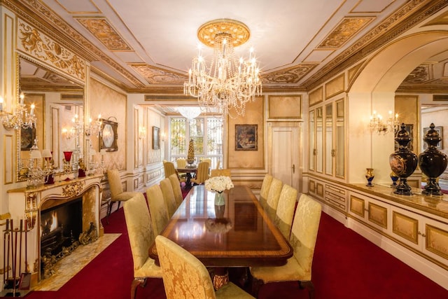 dining space featuring an inviting chandelier, a fireplace, and ornamental molding