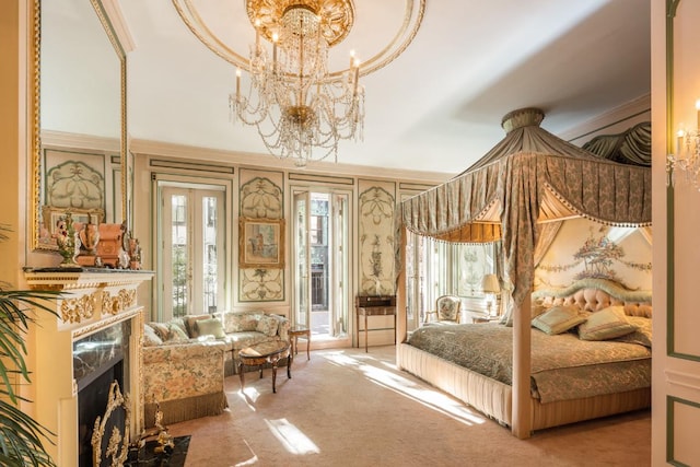 bedroom with a notable chandelier, access to exterior, a fireplace, and multiple windows