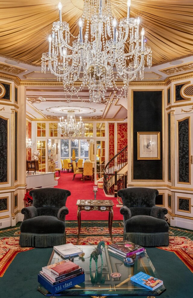 living area with an inviting chandelier, crown molding, carpet floors, and a premium fireplace