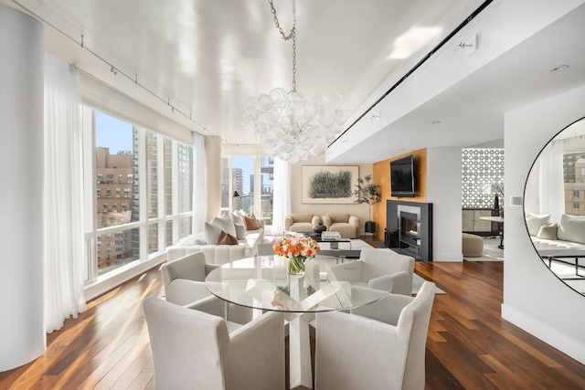 dining space featuring hardwood / wood-style floors and a notable chandelier